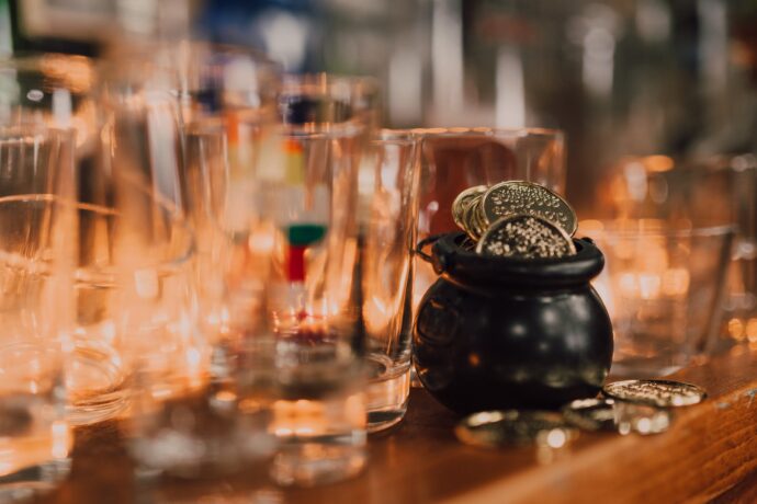 a close up shot of a little cauldron with coins